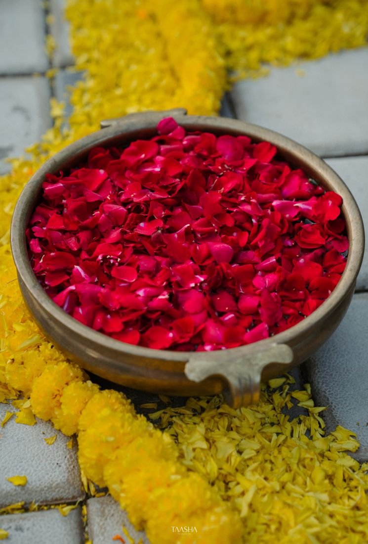 Rose petals in a brass urli bowl